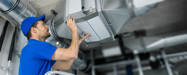 worker checking hvac system