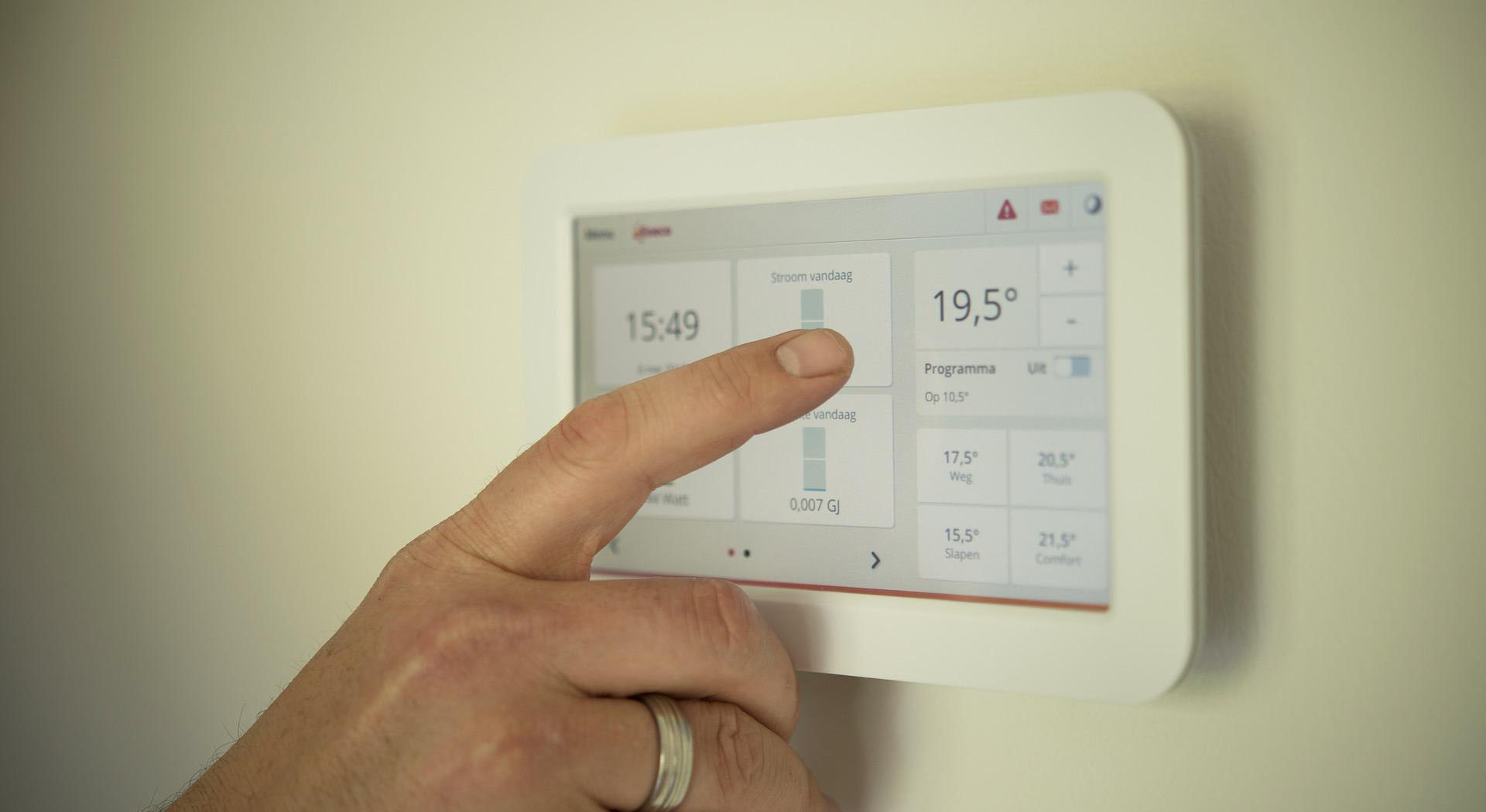 person controlling thermostat